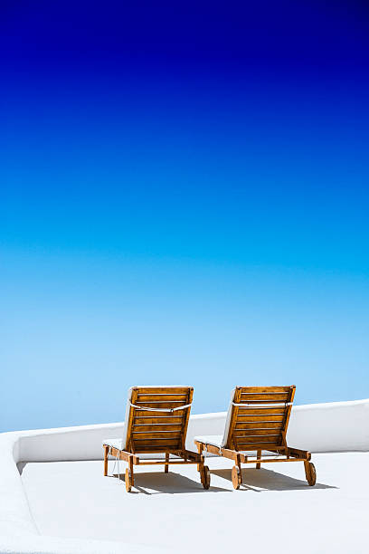 istock Empty Sun Lounge Chair on balcony In Santorini at Sunrise 541846572