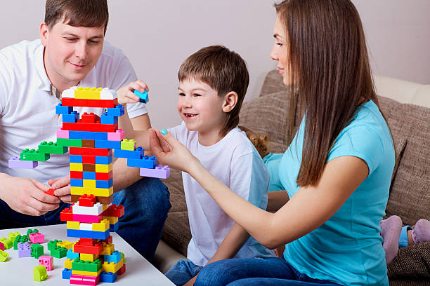 istock Happy family  playing with colorful blocks inside at home. 541848412