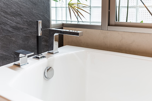 closeup faucet of bathtub in bathroom