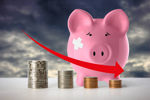 Decrease Stacks of coins in a decrease financial concept. new york state tax stock pictures, royalty-free photos & images