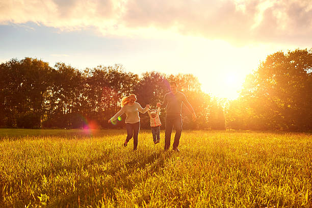 istock Happy family playing on the grass in  park  evening. 541849232