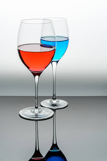 istock two glasses with blue colored water and wine 541849622