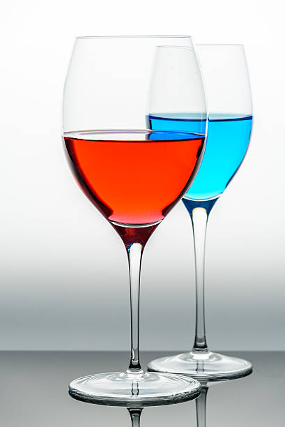 istock two glasses with blue colored water and wine 541849634