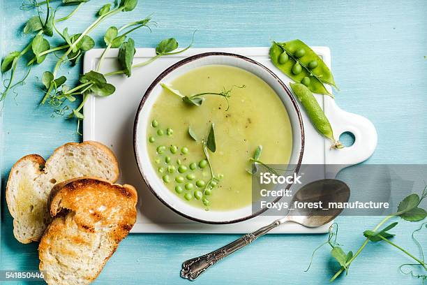 Light Summer Green Pea Cream Soup In Bowl With Sprouts Stock Photo - Download Image Now