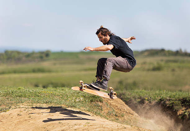istock Profile of skateboarder in action on a dirt road. 541850508