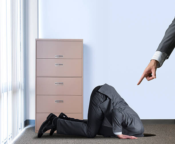 istock Businessman Hiding Head In Hole As Boss Points At Him 541851076