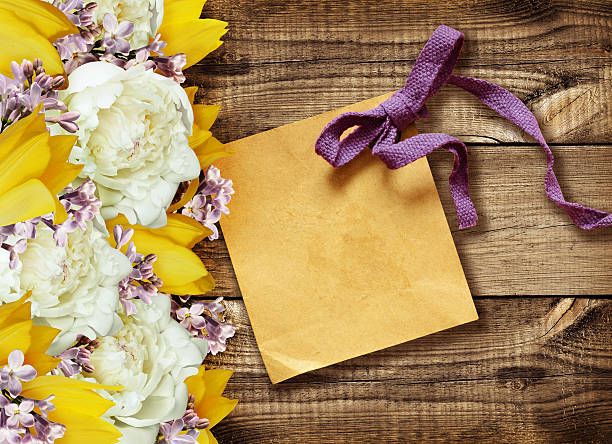 istock Peony, tulips and lilac flowers edgeand a tag 541851222