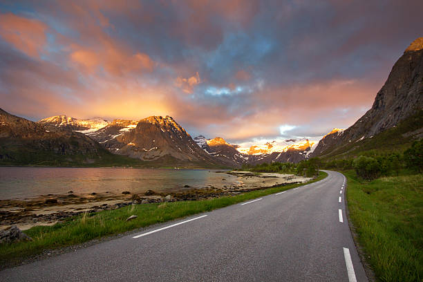 The most beautiful fjord road in northern Norway The Grotfjord road - the most beautiful road to drive through during the midnight sun in northern Norway midnight sun stock pictures, royalty-free photos & images