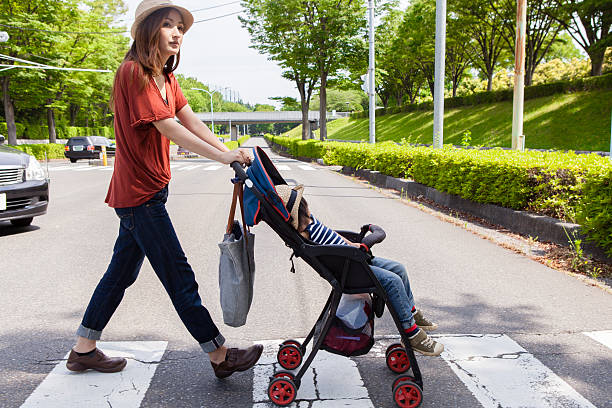 istock Mom it is across the signal while pushing the stroller 541852706