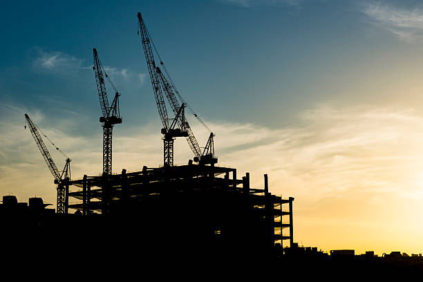 istock Industrial construction cranes and building silhouettes 541854954
