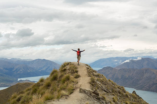 istock Hiker on mountain top, celebrates achievement 541855756