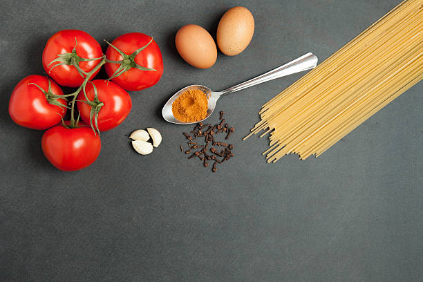 istock food concept. Raw pasta, tomatoes, garlic, flour and eggs 541856238