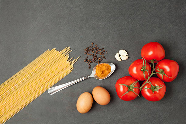 istock food concept. Raw pasta, tomatoes, garlic, flour and eggs 541856294