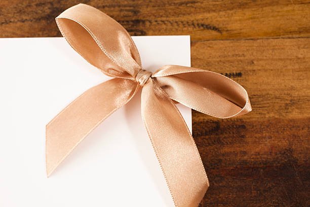 istock Letter, envelope, brown ribbon on wooden table. 541857090