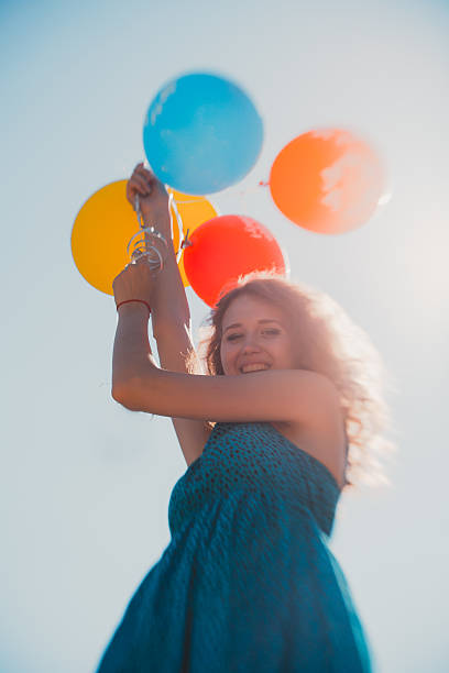 istock young woman with ballons 541860200