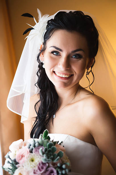 istock beautiful young happy  bride standing near the window 541865050