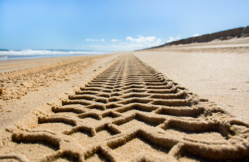 Wheel track on sand beach