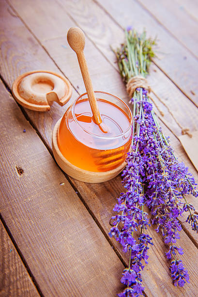 istock honey, pollen, lavender on a wooden background 541867104