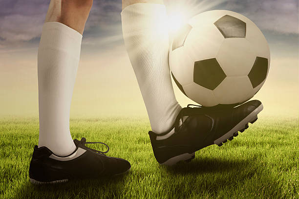 istock Foot of soccer player doing a trick with ball 541869426