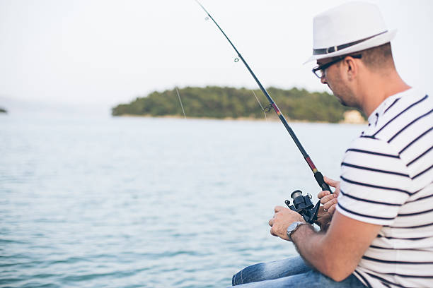 istock Sailor fishing on a dock 541869564
