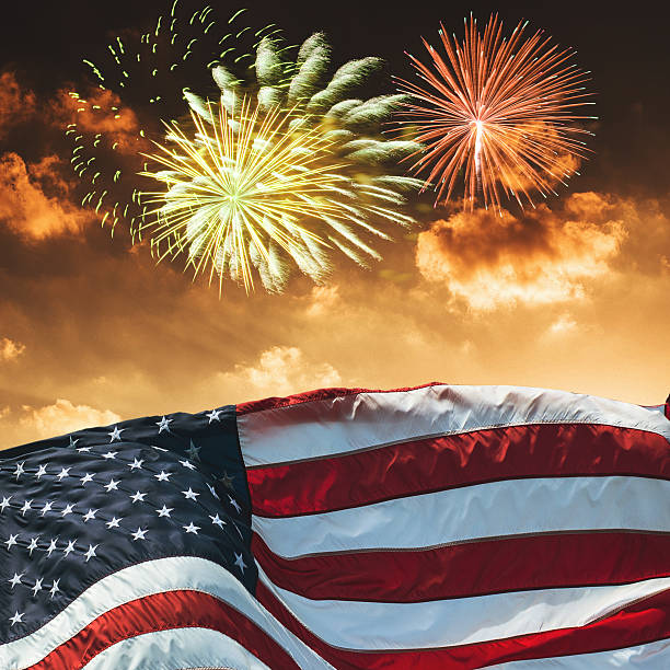 istock american flag waving for a national holiday with fireworks 541969364