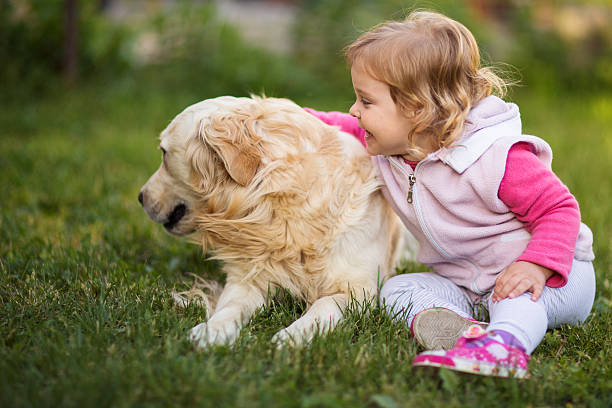istock Baby girl with a dog 541969534