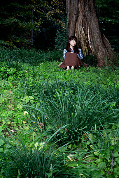 istock The lady who sits down at a forest 541970116