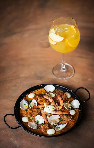 Photo of spanish seafood and rice paella risotto with sangria set