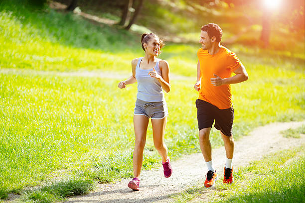 istock Athletic couple jogging in nature 541972636
