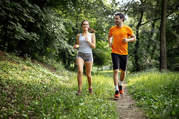 istock Healthy couple jogging in nature 541972772