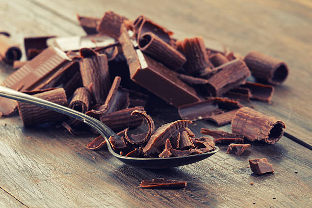 istock Dark chocolate shavings on a wooden table 541975736