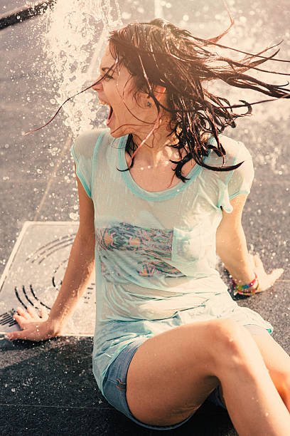 istock Girl having fun in a water fountain 541976306