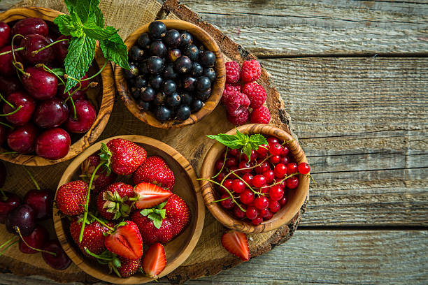 istock Selection of colorful berries on rustic background 541976454