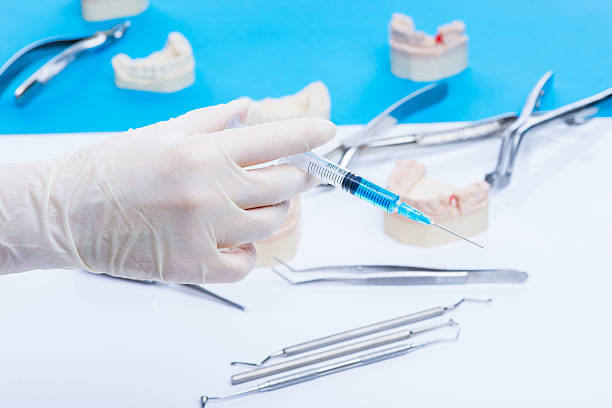 istock Dentist shows how to do the injection 541979886