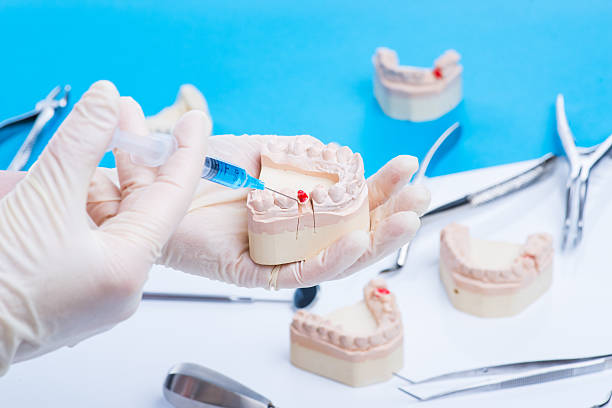 istock Dentist shows how to do the injection 541980622