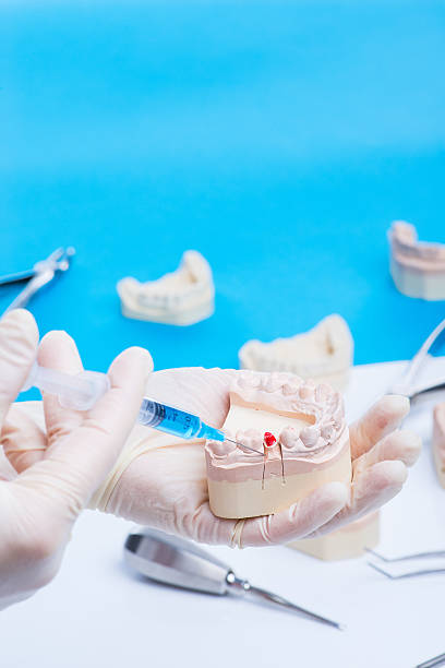 istock Dentist shows how to do the injection 541980714