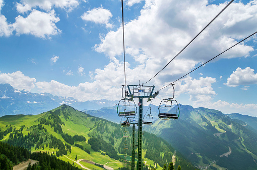 Beautiful green landscape with white clouds in the French Alps