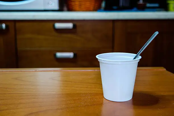 white plastic cup of empty yogurt