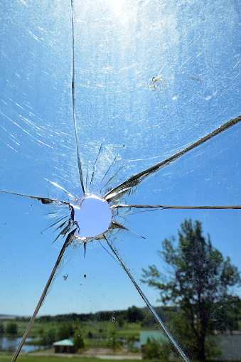 Hole in a dirty old window