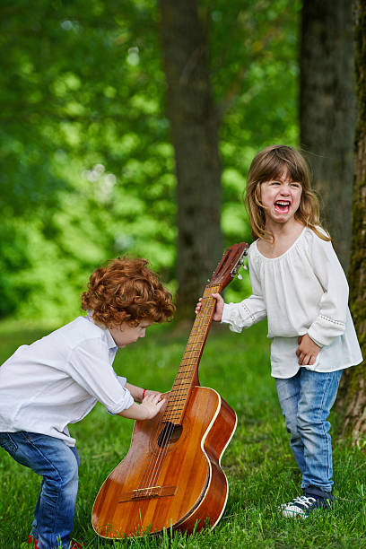 istock cute children playing guitar 541985166