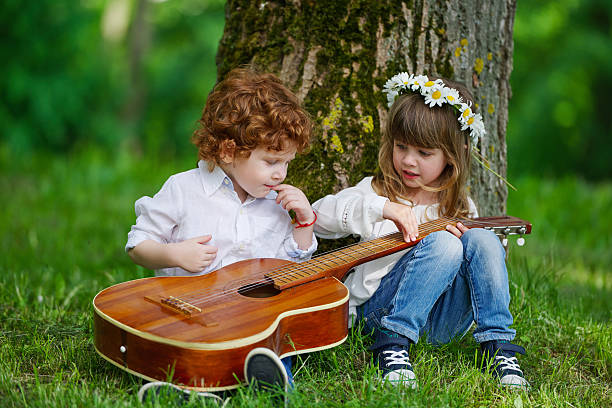 istock cute children playing guitar 541985444