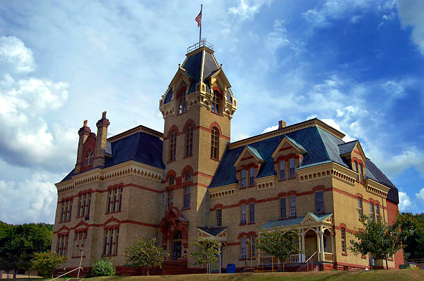 Houghton Pride and Joy Victorian era county courthouse in Houghton, Michigan is designed with local red sandstone and Lake Superior copper for the roof. Houghton County Courthouse is over 120 years old. copper dormer stock pictures, royalty-free photos & images