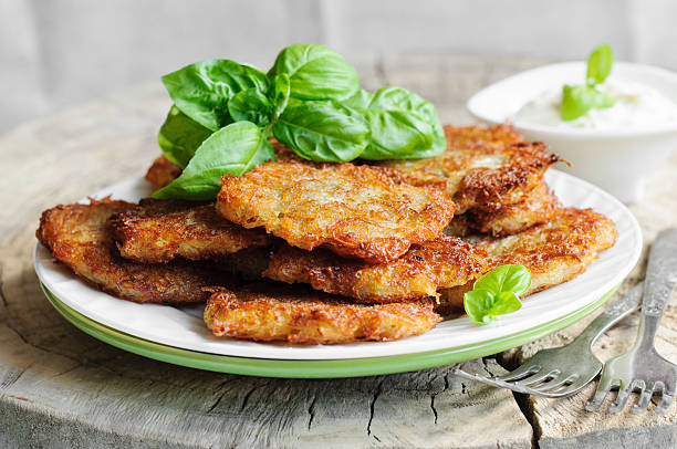Potato pancakes and sour cream in plate