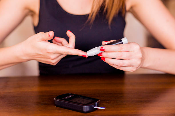 istock Woman Doing Blood Sugar Test at home 541987810