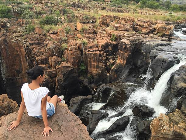 istock Girl looking at a waterfall 541988602