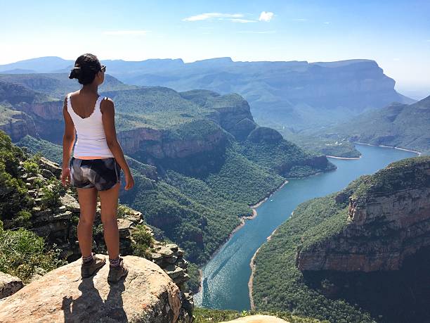 istock Girl standing in front of a canyon 541988718