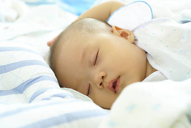 istock Baby girl sleeping on her bed. 541989646