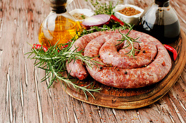 istock raw beef sausages on a cast-iron pan,  selective focus 541991782