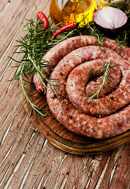 istock raw beef sausages on a cast-iron pan,  selective focus 541991962
