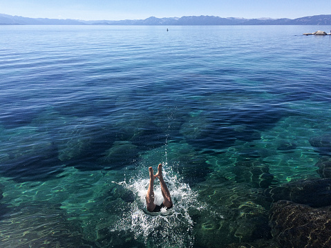 A man jumps into Lake Tahoe